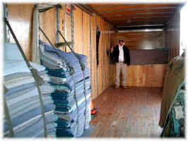 Interior of a Classic Moving & Storage truck loaded with blanket-wrapped furniture