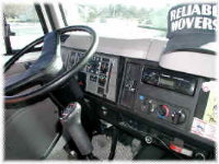 Driver's cab of a Reliable Movers truck, clean and fully equipped
